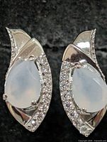 Front view showing moonstone cabochons and accent stones