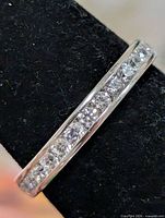 Channel-set CZ stones across top of sterling silver band