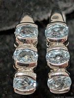 front view showing six blue topaz stones set in silver