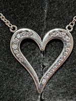 Close-up of heart pendant face showing cubic zirconia setting