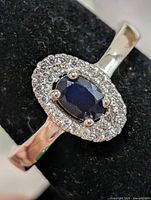 Front view of ring showing sapphire center and CZ halo