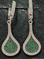 front view of both earrings showing green and clear CZ arrangement