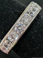 Side view of silver band with six round CZ stones