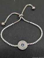 Full view of silver bolo bracelet with CZ links and evil-eye charm