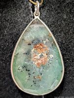 Front view of teardrop pendant showing gemstone color and inclusions