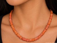 Necklace worn on model showing full strand and bead color