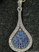 front view of teardrop pendant with blue and clear CZ