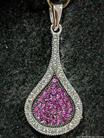 Front view of teardrop silver pendant with clear and pink CZ