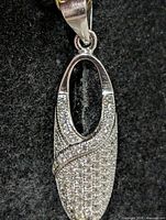 Front view of sterling silver oval pendant with pave CZ