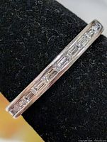 Front view showing channel-set baguette CZ stones on silver band