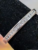 Close-up of channel-set CZ stones along top of silver band