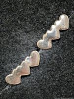 front view of both earrings showing heart motif