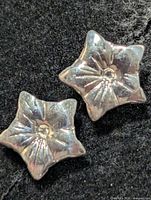 front view of both silver star flower stud earrings