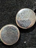 front view of both round silver disc earrings