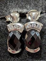 Front view of both earrings showing garnet stones and accent stones
