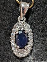 front view of oval sapphire and CZ halo pendant