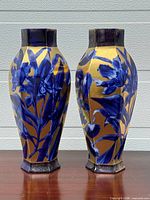 Front view of both vases showing blue floral on gold and shape