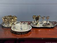 Group shot of goblets, three trays and glass tumblers