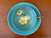 Top view of saucer showing turquoise color and gold floral motif