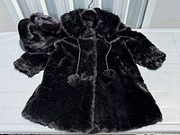 Jacket laid flat with matching hat and mittens visible