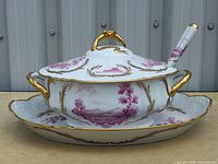 Full view of soup tureen on underplate showing pattern and gilt trim