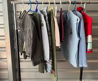Full rack of nine garments on hangers