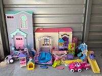 Full lot view showing two dollhouses, vehicles, playground pieces and accessories