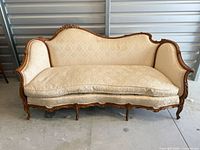 Front view of carved walnut sofa