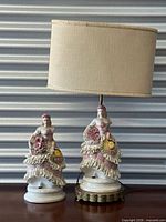 Front view of both porcelain figures, lamp with shade