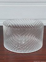 front view of clear pressed glass bowl showing cylindrical form and chevron pattern