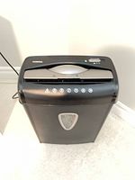 Front view of black AmazonBasics cross-cut shredder showing bin window and overall form