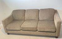 Front view of full sofa showing upholstery, cushions and feet
