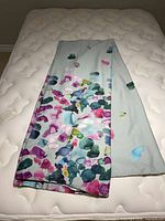 Folded duvet cover on mattress showing main watercolor floral pattern