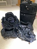 Group shot showing all five travel bags including rolling suitcase