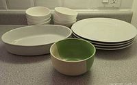 Group view of plates, bowls, oval dish and green bowl