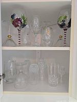 Cabinet shelves showing all assorted glassware pieces
