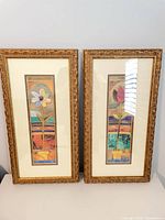 Front view showing both framed floral prints, artwork, mats, and gold ornate frames