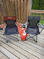 Both folding chairs unfolded on deck with carry bag