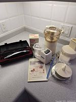 Group shot of all appliances, accessories and rotary grater box