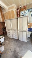 Three beige Sterilite plastic cabinets side by side