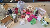 Full lot overview on tabletop showing all bath, body, candles, socks and accessories