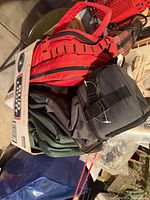 Group of bags and accessories stacked in cardboard carton