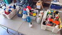 Overview of all cleaning products grouped in three baskets on table