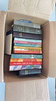 Box containing approximately sixteen assorted Christian Bibles and devotional books