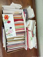 box filled with assorted greeting cards and envelopes viewed from top