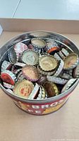 Coffee tin full of assorted vintage soda caps