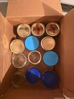 Top view of jars in box showing mixed gold and blue lids