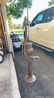 Full view of cast iron pump standing on driveway