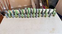 Row of all ceramic chess pieces showing both color sets