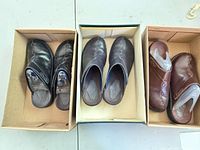 Three pairs Clarks leather mules in boxes